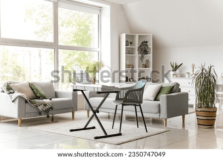 Interior of stylish living room with modern synthesizer and sofas