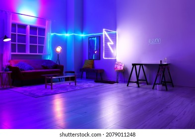 Interior of stylish living room with neon lighting - Shutterstock ID 2079011248