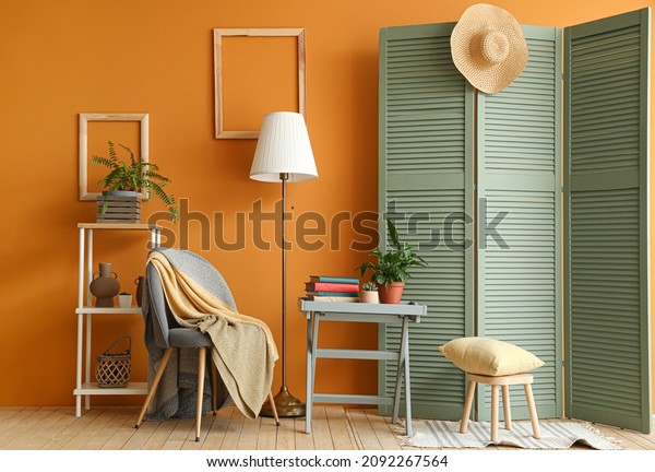 Interior of stylish\
room with folding\
screen