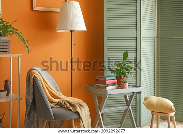 Interior of stylish\
room with folding\
screen
