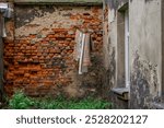 interior of a tenement house, yard in an abandoned, neglected and ruined tenement house in the city center. shabby walls of tenement houses. hanging old rags, rugs and clothes on a line and a clothes 