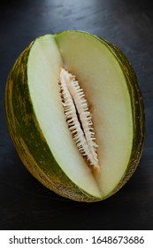 Interior Of A Toad Skin Melon On Black Background