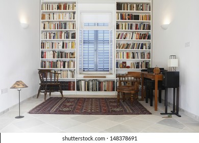 Interior of town house with books arranged in library