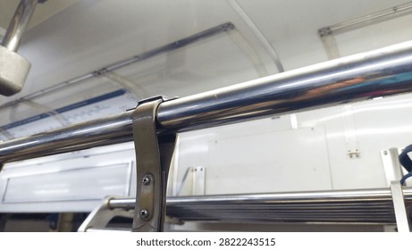 Interior of the train, consisting of a ceiling and handrails for passengers to hold onto, thereby enhancing safety and comfort