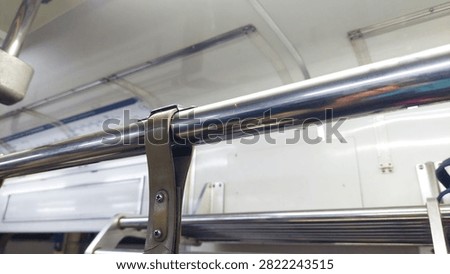 Interior of the train, consisting of a ceiling and handrails for passengers to hold onto, thereby enhancing safety and comfort