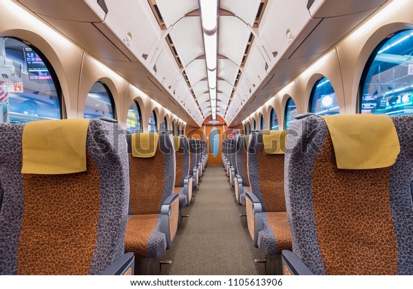 Interior\
of a train with empty seats. Modern train\
seats.