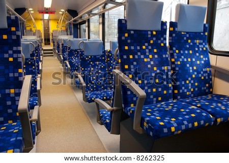 Interior of a train wagon with many seats