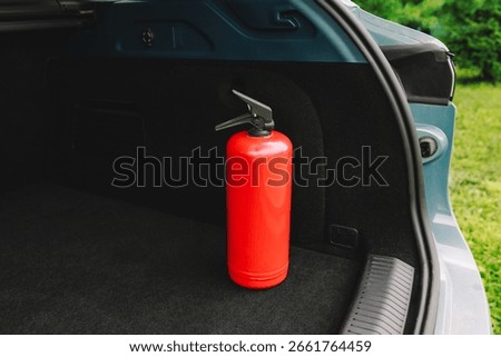 The interior of the trunk of the car in which there is red fire extinguisher