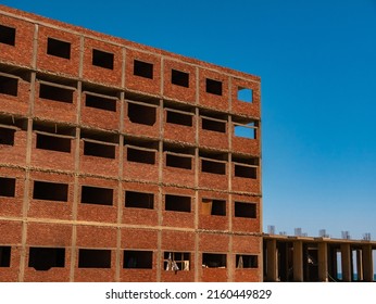 Interior Of A Unfinished Red Brick House Under Construction. Close Up On Windows Hole Construction.