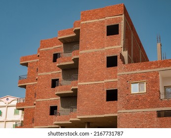 Interior Of A Unfinished Red Brick House Under Construction. Close Up On Windows Hole Construction.