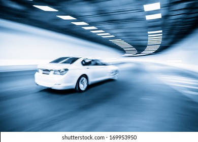 Interior of an urban tunnel with car,motion blur