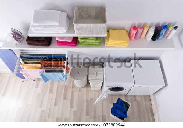 Interior Of Utility Room With Washing Machine And\
Drying Clothes