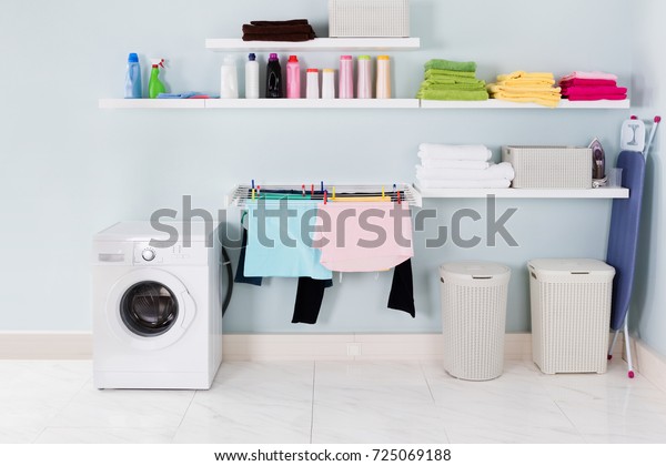 Interior Of Utility Room With Washing Machine\
And Cleaning Equipment
