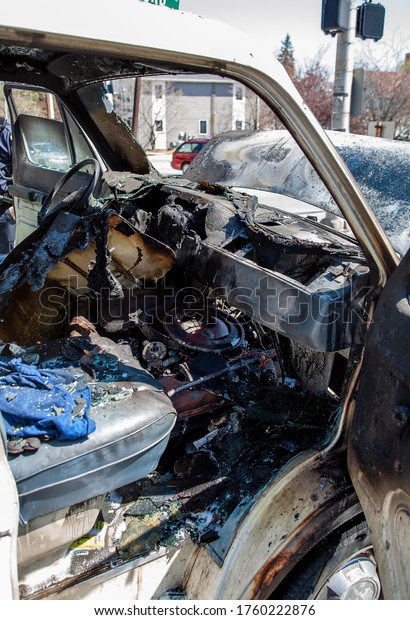 The interior of a van heavily damaged by an engine\
compartment fire