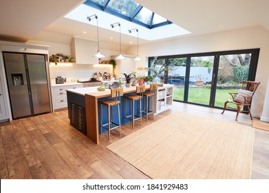 Interior View Of Beautiful Kitchen With Island Counter And Table For Children In New Family House