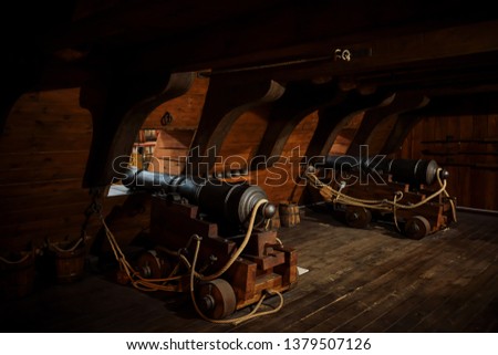 interior view of Cannons At The Deck and Cannon Balls plus windows on old galleon with ropes