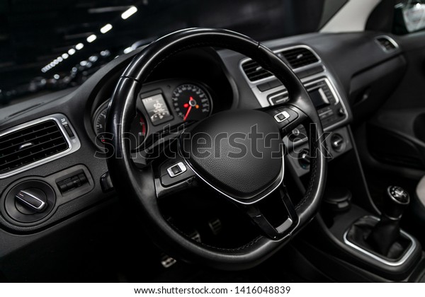 Interior view\
of car with black salon. Modern luxury prestige car interior:,\
dashboard, speedometer, tachometer  with white backlight  steering\
wheel  with car controller system\
function.