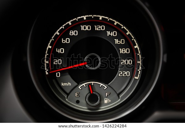 Interior view of car with\
black salon. Modern luxury prestige car interior: speedometer,\
dashboard and tachometer  with white backlight and other buttons.\
Soft focus 