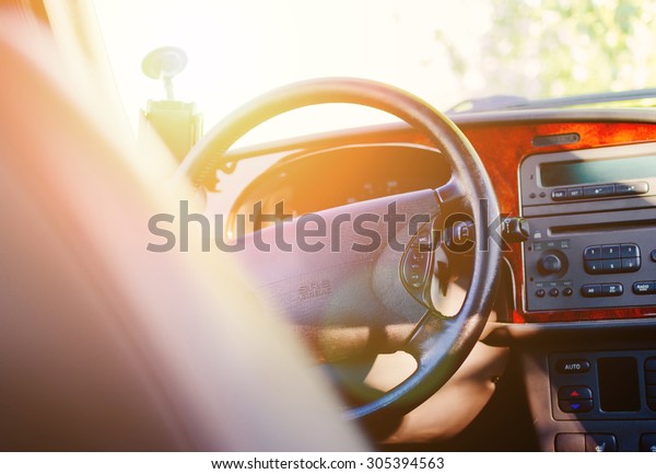 Interior view\
of car with black salon in sunset\
time