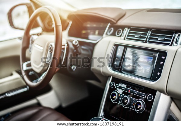 Interior view of car, Luxury\
car steering wheel and clean dashboard with display or monitor\
screen.