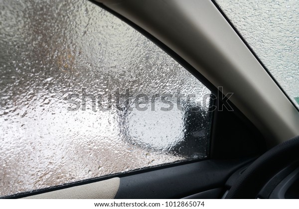 Interior view of car\
window in frozen rain