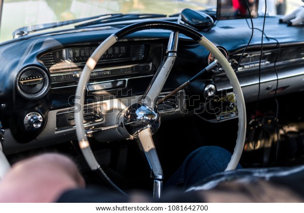 Interior view of classic vintage car.\
Beautiful retro car, interior elements, chrome and wood, the\
concept of expensive collector cars, premium\
class