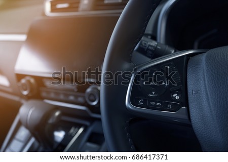 interior view of communication button on steering wheel of modern car