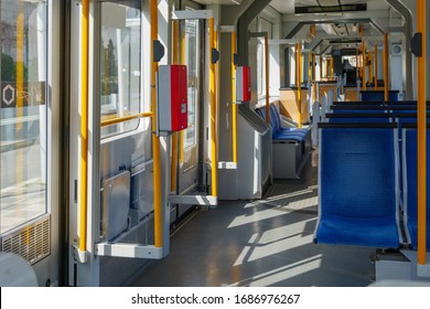 Interior view of a corridor inside passenger trains with blue fabric seats of German railway train system. Empty vacant passenger car inside the Tram.