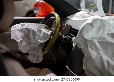 Interior view of crashed car with deployed airbags.