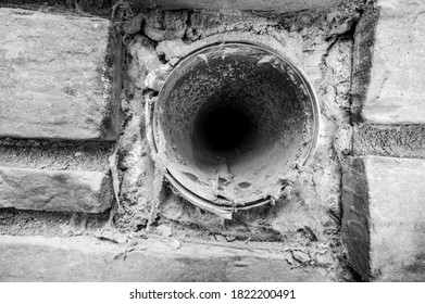 Interior view of dryer vent line with lint and dust buildup
