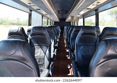Interior view of empty bus seats background.