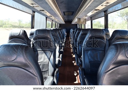 Interior view of empty bus seats background.