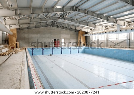 Interior view of empty indoor swimming pool construction inside a modern sports complex