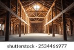 interior view of a huge wooden barn, with wooden columns, dirt floor, texas barn