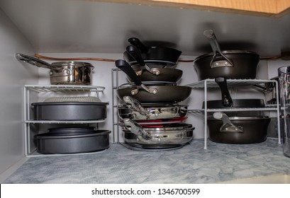 Interior View Of Kitchen Cabinet With Pots And Pans Inside