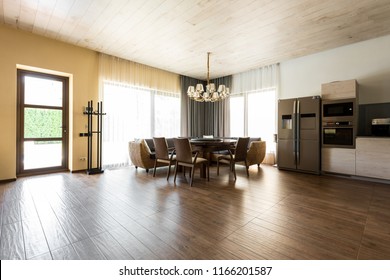 interior view of modern kitchen and dining room with table and chairs 