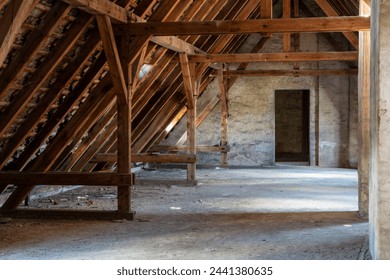 Interior view of an old attic with wooden beams. - Powered by Shutterstock