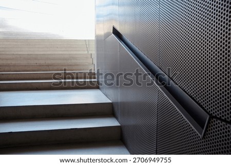 Interior view of the staircase at Casa da Música in Porto, Portugal, featuring the building’s distinctive handrail that is uniquely integrated into the side wall