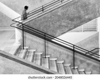 Interior view of a unrecognized people walking upstairs  - Shutterstock ID 2048026445