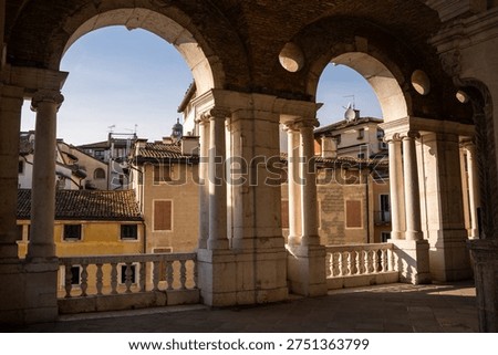 Interior view of the upper loggia of the Basilica Palladiana showing the iconic Palladian window arches and light shadows in Vicenza, Italy 08.01.2026