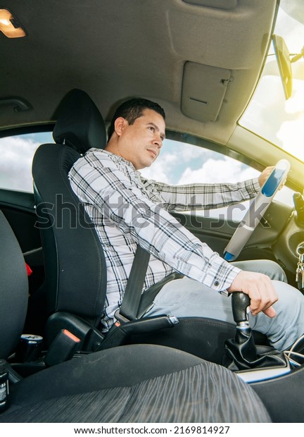 Interior view of a young man driving a car, A happy\
man driving a car, Side view of a man driving a car, concept of man\
brand new car
