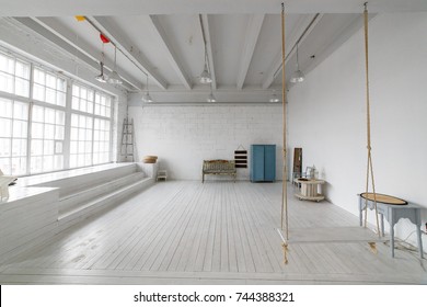 Interior with vintage furniture, light studio with old bench and blue case. Spacious studio with a high ceiling and a big window for photo shooting. Natural light