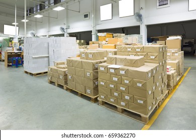 Interior of a warehouse with pallet stacker, boxes.