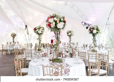 Interior Of A Wedding Tent Decoration Ready For Guests. Served Round Banquet Table Outdoor In Marquee Decorated Flowers And Silk. Catering Concept