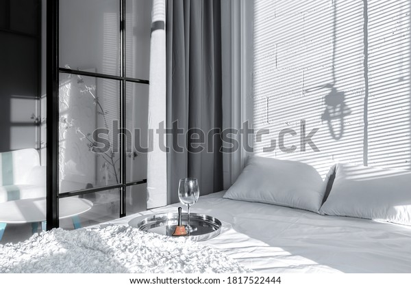 The interior is in white. Bedroom separated by\
a glass partition
