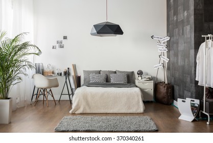 Interior of white and gray cozy bedroom - Shutterstock ID 370340261