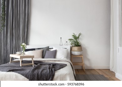 Interior of white and gray cozy bedroom - Shutterstock ID 593768396