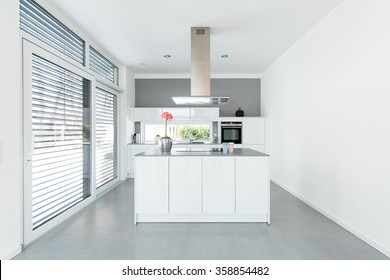 Interior of white kitchen with big windows - Shutterstock ID 358854482