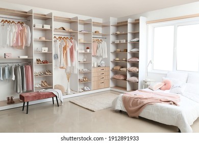 Interior of white modern bedroom with wardrobe - Shutterstock ID 1912891933