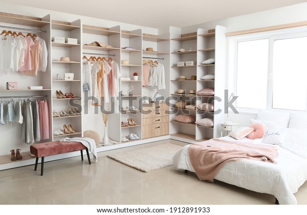 Interior of white\
modern bedroom with\
wardrobe